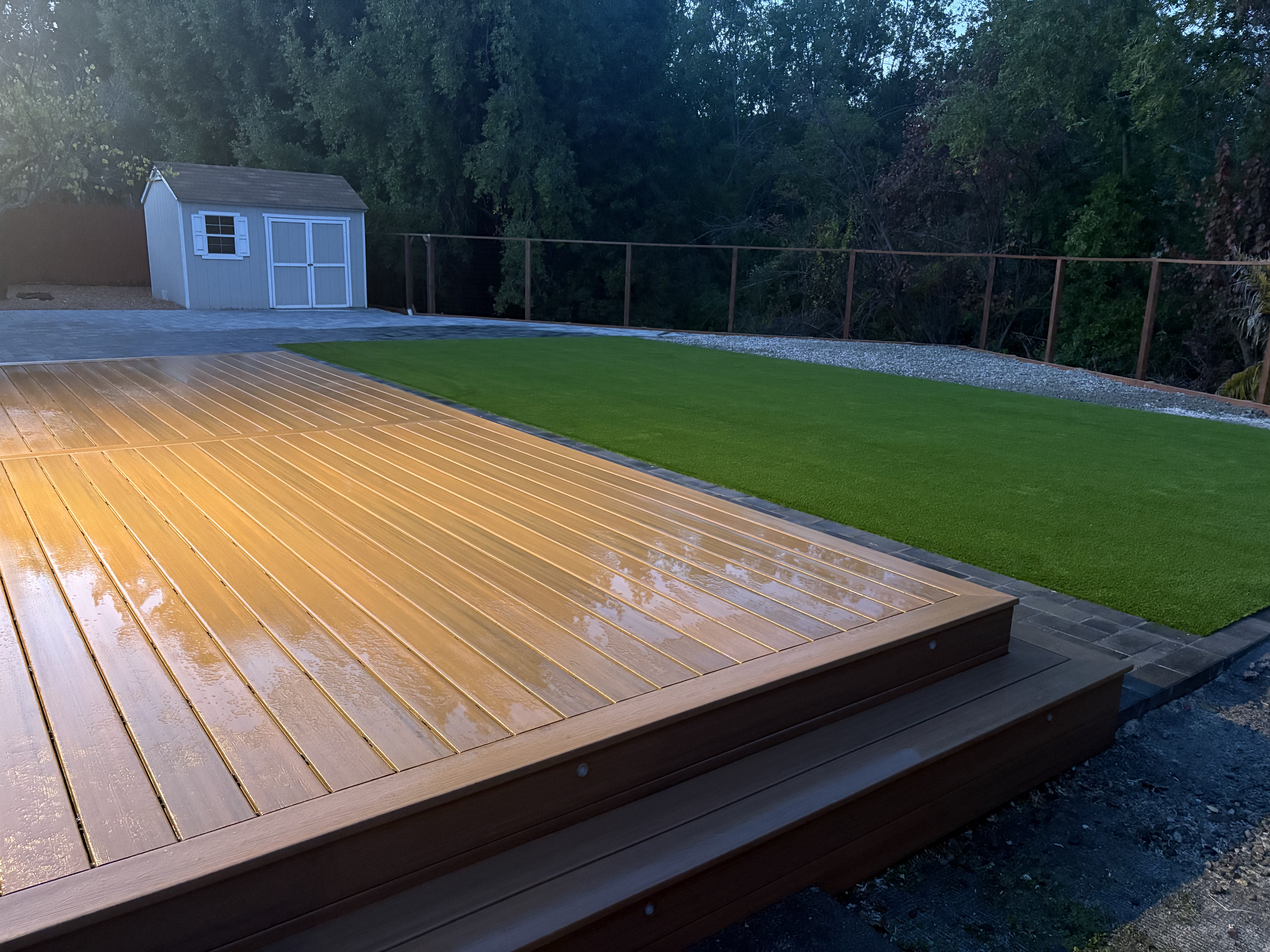 Wood deck with artificial turf lawn and paver border
